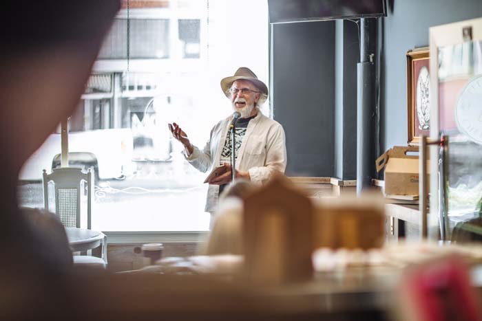 Bill Vartnaw introduces the poets at the Petaluma Cheese Shop. Photo by Michael Woolsey.